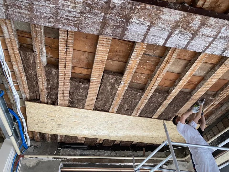 Freigelegte Holzbalkendecke während der Rückbauarbeiten.